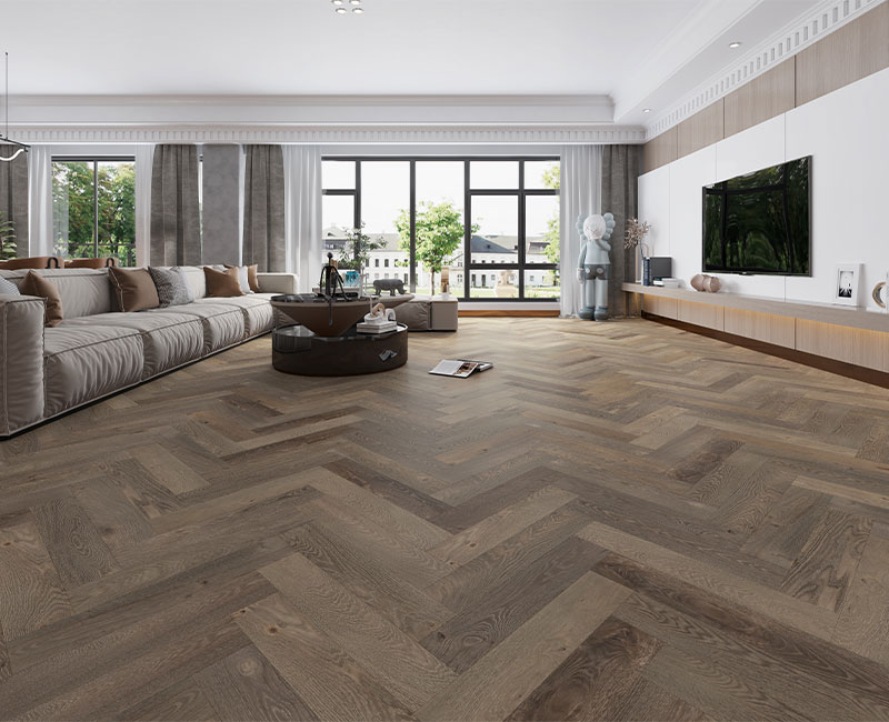 dark herringbone hardwood floorign in living room with modern decor.